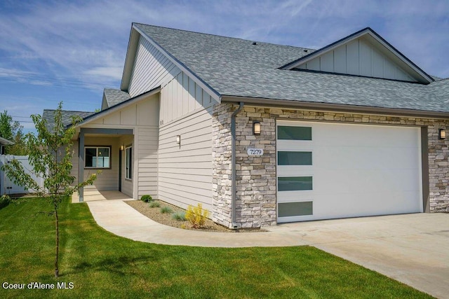7279 N Grafton St, Coeur Dalene, ID 83815 - view of front facade featuring board and batten siding, a shingled roof, concrete driveway, and stone siding