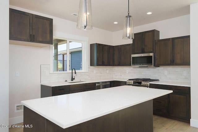 7279 N Grafton St, Coeur Dalene, ID 83815 - kitchen with stainless steel appliances, a sink, dark brown cabinetry, light countertops, and recessed lighting
