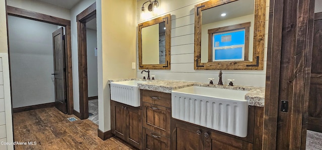full bath featuring vanity, baseboards, and wood finished floors