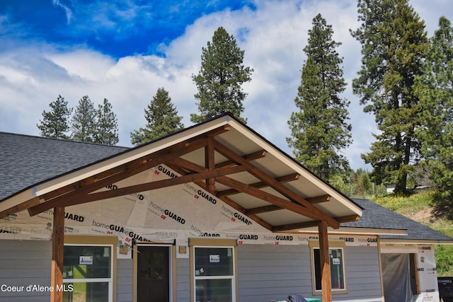 exterior space with a shingled roof