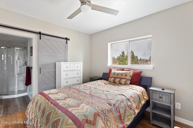 bedroom featuring baseboards, a barn door, ceiling fan, and wood finished floors
