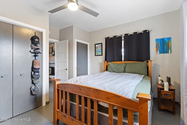 bedroom with a fireplace, a closet, and ceiling fan