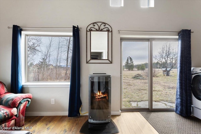 interior space featuring baseboards, wood finished floors, and washer / dryer