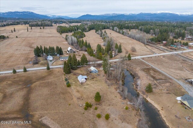 drone / aerial view featuring a rural view and a mountain view