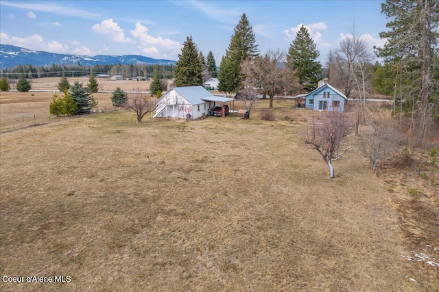 birds eye view of property featuring a mountain view and a rural view