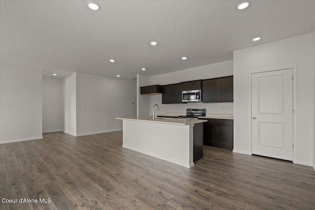 kitchen featuring a sink, dark wood-style floors, recessed lighting, and stainless steel appliances