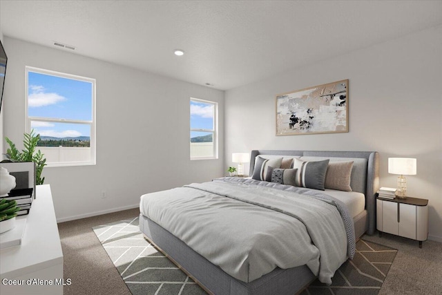 bedroom with visible vents, baseboards, and carpet