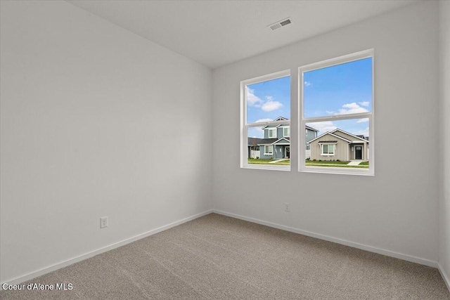 carpeted empty room with baseboards and visible vents