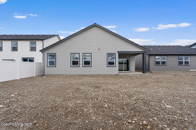 back of property featuring a patio area and fence