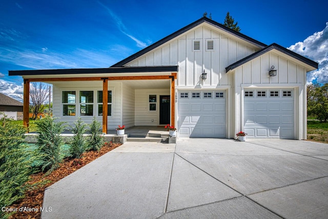 1690 Irvine Way, Sandpoint, ID 83864 - view of front facade featuring driveway, board and batten siding, a garage, and a porch