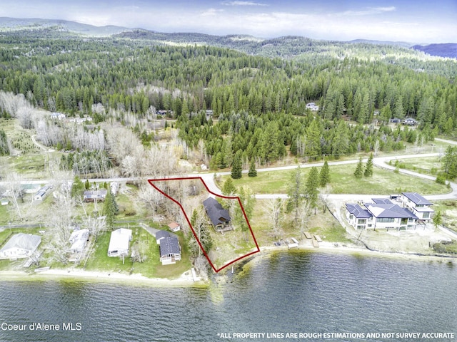 bird's eye view with a forest view and a water and mountain view