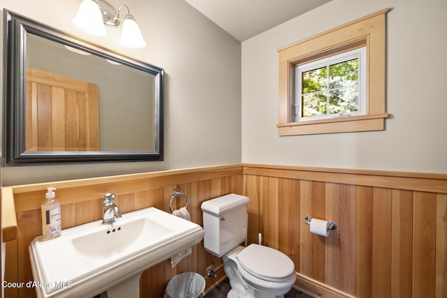 4459 E Ogara Rd, Harrison, ID 83833 - bathroom with toilet, a sink, and wainscoting