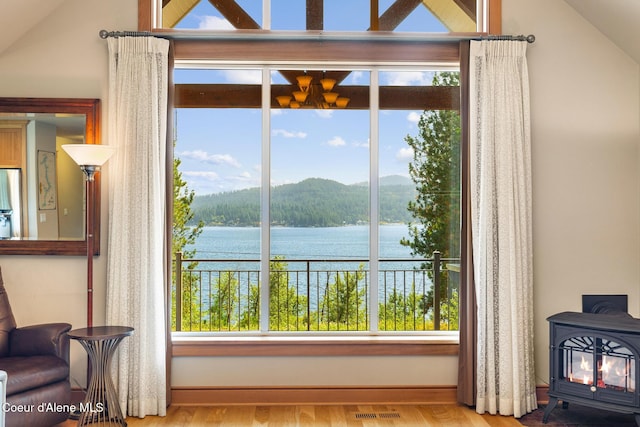 4459 E Ogara Rd, Harrison, ID 83833 - room details featuring a water and mountain view, visible vents, a wood stove, and wood finished floors