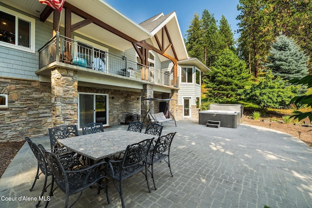 4459 E Ogara Rd, Harrison, ID 83833 - view of patio / terrace with a balcony, outdoor dining area, and a hot tub