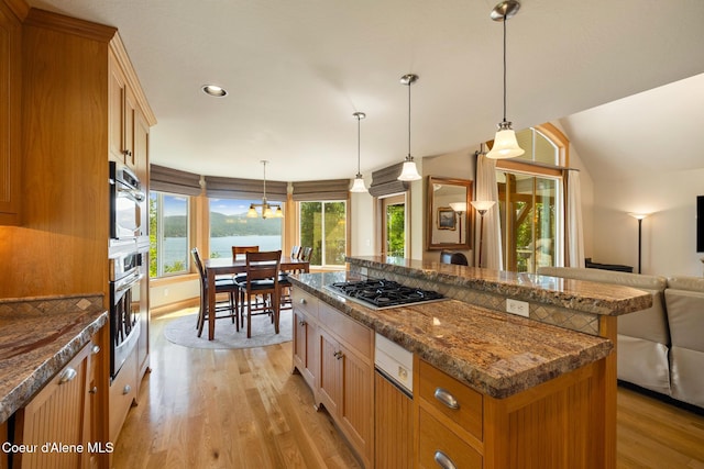 4459 E Ogara Rd, Harrison, ID 83833 - kitchen with light wood-style flooring, stainless steel gas cooktop, open floor plan, pendant lighting, and a center island