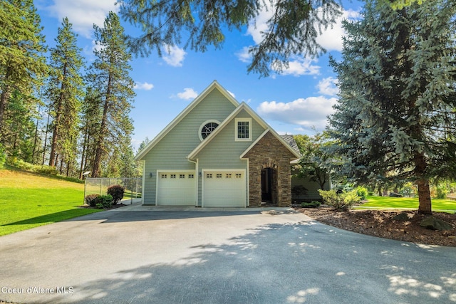 4459 E Ogara Rd, Harrison, ID 83833 - craftsman inspired home featuring stone siding, fence, a garage, a front lawn, and driveway