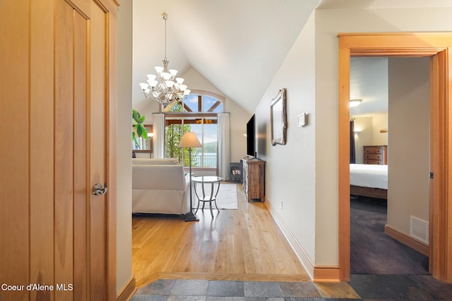 4459 E Ogara Rd, Harrison, ID 83833 - hallway with baseboards, visible vents, wood finished floors, and lofted ceiling