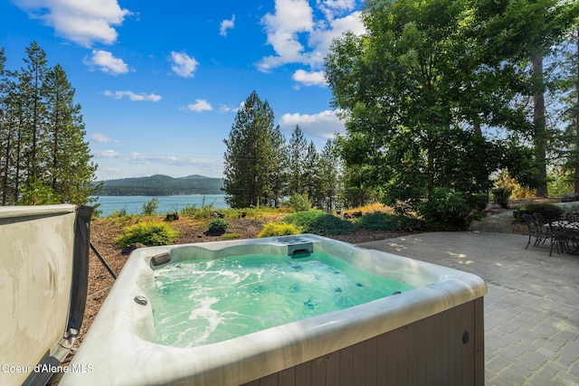4459 E Ogara Rd, Harrison, ID 83833 - view of swimming pool featuring a water view, a patio, and a hot tub
