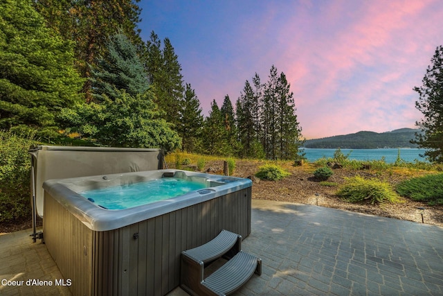 4459 E Ogara Rd, Harrison, ID 83833 - view of patio featuring a water view and a hot tub