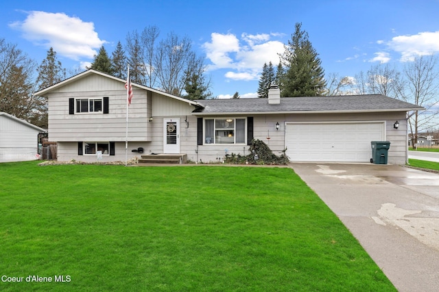 tri-level home featuring driveway, an attached garage, a front lawn, and a chimney