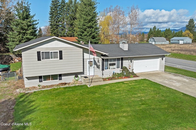 split level home featuring concrete driveway, an attached garage, and a chimney