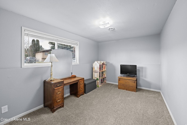 home office featuring light carpet and baseboards