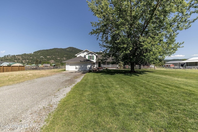 5904 N 15th St, Dalton Gardens, ID 83815 - view of front of property with an attached garage, a mountain view, and gravel driveway