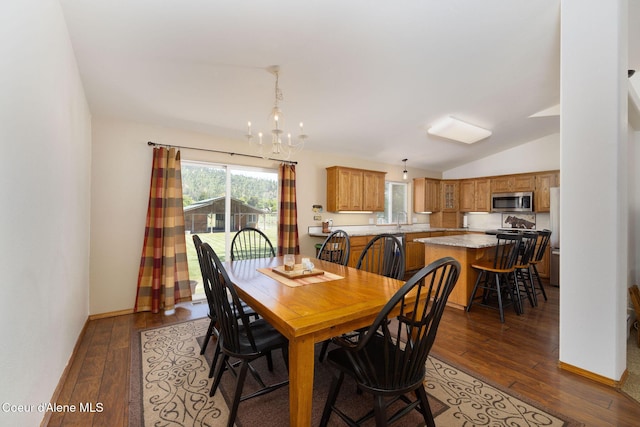 5904 N 15th St, Dalton Gardens, ID 83815 - dining space featuring dark wood finished floors, a chandelier, vaulted ceiling, and baseboards
