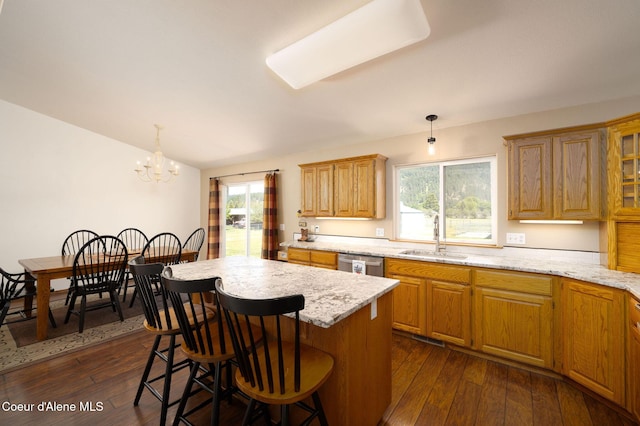 5904 N 15th St, Dalton Gardens, ID 83815 - kitchen with a sink, stainless steel dishwasher, dark wood finished floors, a breakfast bar, and pendant lighting