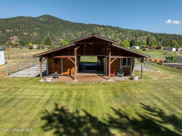 5904 N 15th St, Dalton Gardens, ID 83815 - view of outbuilding featuring an exterior structure, a wooded view, a mountain view, and an attached carport