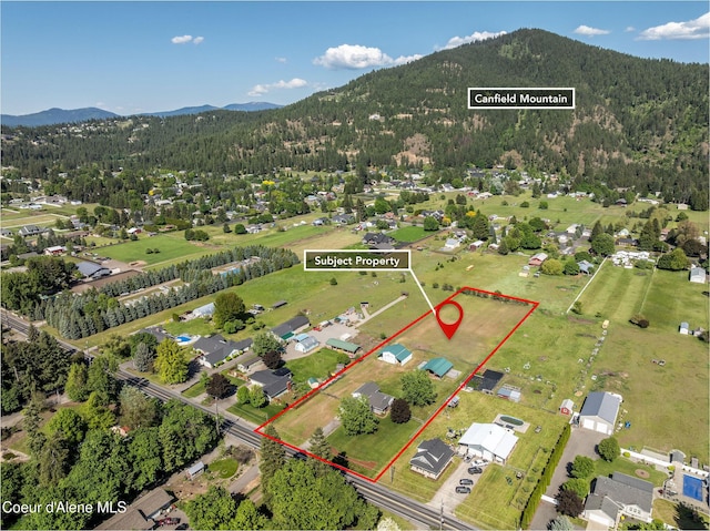 5904 N 15th St, Dalton Gardens, ID 83815 - view of property location featuring a mountain backdrop, a heavily wooded area, and property boundaries highlighted