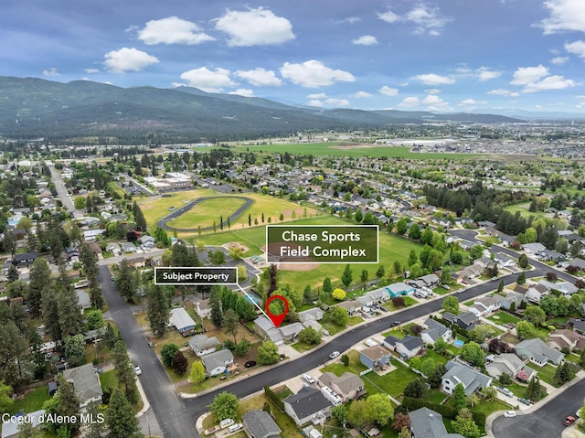 405 W 22nd Ave, Post Falls, ID 83854 - aerial view of property and surrounding area with a mountainous background and nearby suburban area