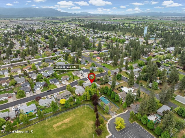 405 W 22nd Ave, Post Falls, ID 83854 - aerial view of property and surrounding area with a mountainous background and nearby suburban area