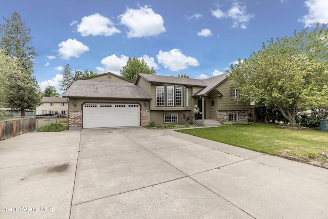 405 W 22nd Ave, Post Falls, ID 83854 - bi-level home featuring brick siding, a garage, driveway, and a shingled roof