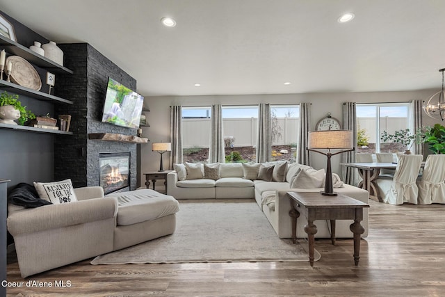 5441 W Gumwood Cir, Post Falls, ID 83854 - living room with a fireplace, wood finished floors, recessed lighting, and a notable chandelier