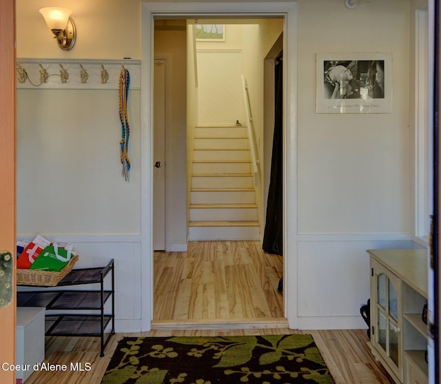 723 Pine St, Sandpoint, ID 83864 - corridor featuring a wainscoted wall, stairs, and wood finished floors