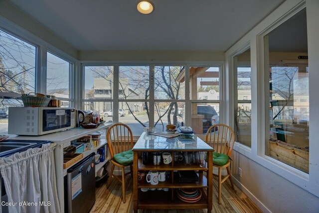 723 Pine St, Sandpoint, ID 83864 - sunroom / solarium with baseboards, wood finished floors, and a healthy amount of sunlight