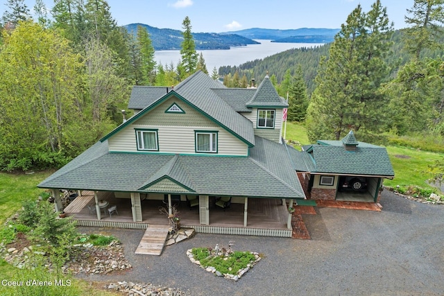 3467 E Sunset Dr, Harrison, ID 83833 - victorian house featuring a mountain view, a view of trees, covered porch, and driveway