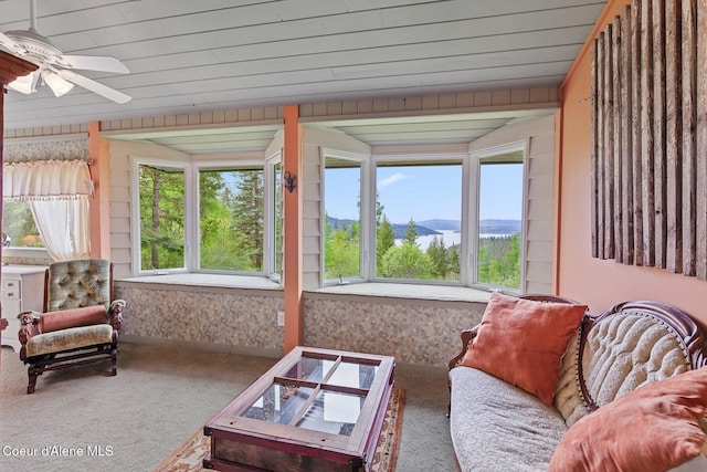 3467 E Sunset Dr, Harrison, ID 83833 - living area featuring carpet, ceiling fan, a mountain view, and vaulted ceiling