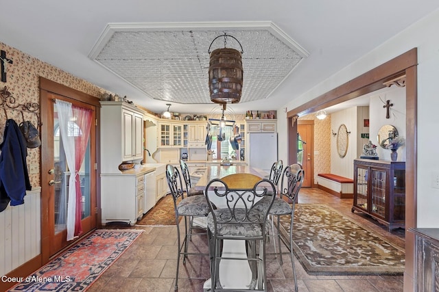 3467 E Sunset Dr, Harrison, ID 83833 - dining room with healthy amount of natural light, stone finish flooring, and wallpapered walls