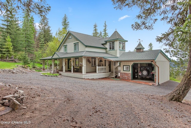 3467 E Sunset Dr, Harrison, ID 83833 - rear view of property featuring covered porch, driveway, a shingled roof, and a carport
