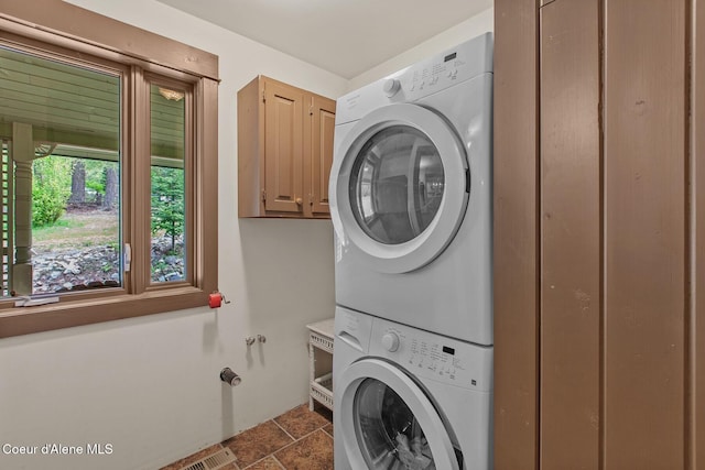 3467 E Sunset Dr, Harrison, ID 83833 - washroom with stacked washing machine and dryer and cabinet space