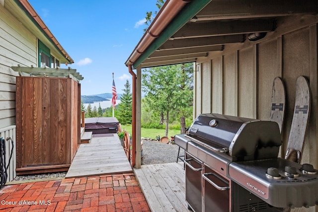 3467 E Sunset Dr, Harrison, ID 83833 - view of patio featuring a covered hot tub and a deck with mountain view