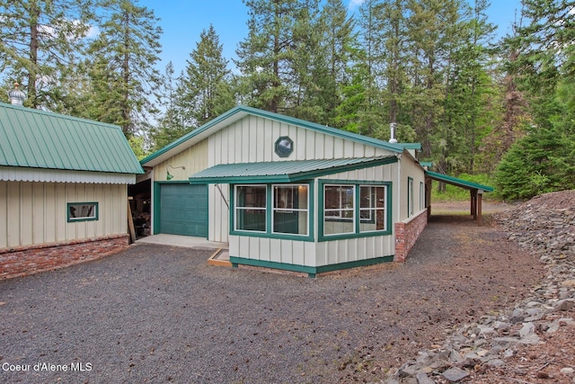 3467 E Sunset Dr, Harrison, ID 83833 - view of front of house featuring driveway, a garage, and board and batten siding