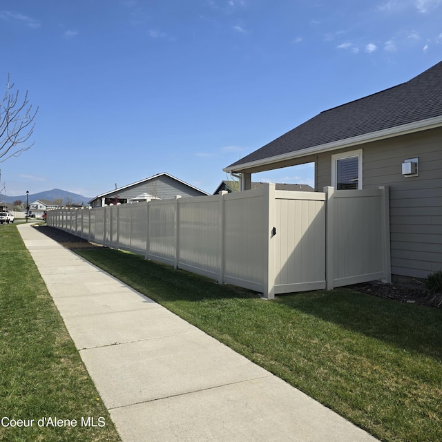 view of yard with a mountain view and fence