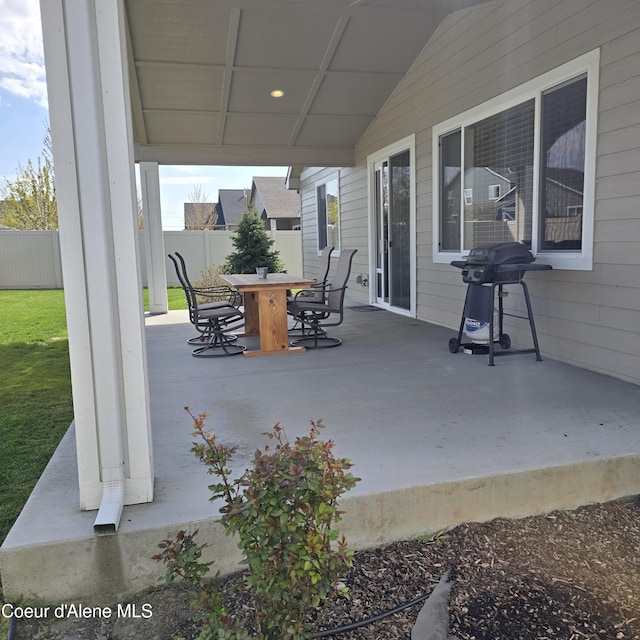 view of patio / terrace featuring outdoor dining space, a grill, and fence