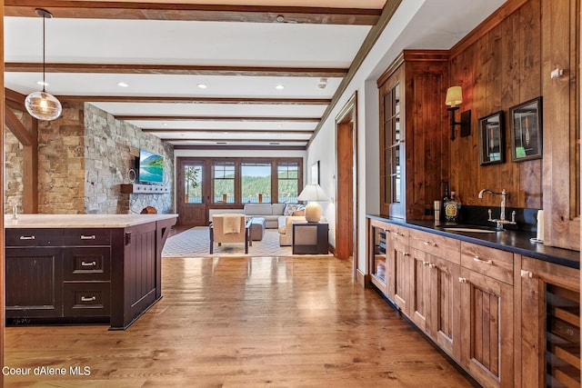 4669 S Arrow Point Dr # 210, Harrison, ID 83833 - kitchen featuring wine cooler, a sink, light wood finished floors, open floor plan, and beamed ceiling