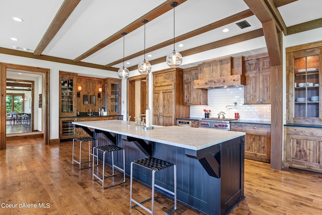 4669 S Arrow Point Dr # 210, Harrison, ID 83833 - kitchen featuring decorative backsplash, visible vents, beamed ceiling, and wood finished floors