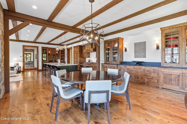 4669 S Arrow Point Dr # 210, Harrison, ID 83833 - dining space featuring plenty of natural light, light wood-style floors, a notable chandelier, and beam ceiling