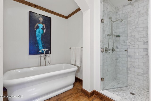 4669 S Arrow Point Dr # 210, Harrison, ID 83833 - bathroom with crown molding, baseboards, a stall shower, a freestanding bath, and wood finished floors